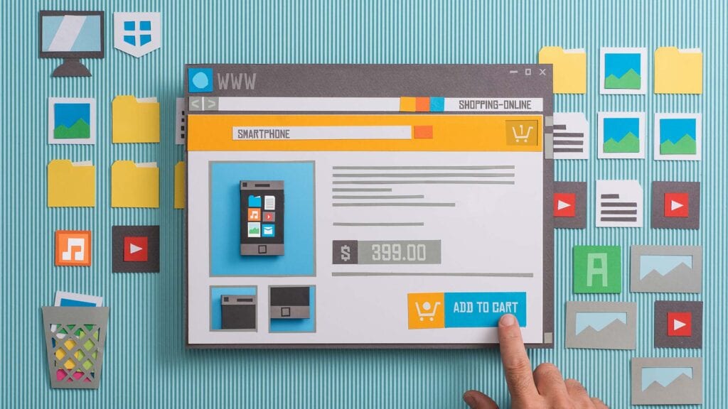 Cardboard cutouts of a mock website design ecommerce layout.