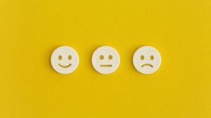 Emoticon smile on a yellow background. Customer feedback.