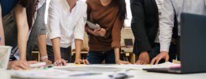 Five business people collaborating in a team meeting.