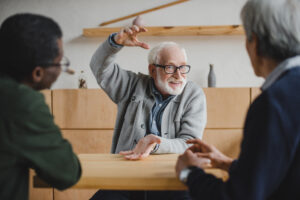 An elderly man sharing the story of his business brand.