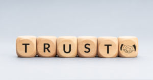 Wooden beads spelling the word Trust.