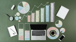 top view of laptop and business charts with cup of coffee and smartphone, laptop computer