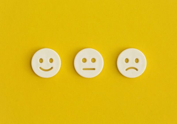Emoticon smile on a yellow background. Customer feedback.