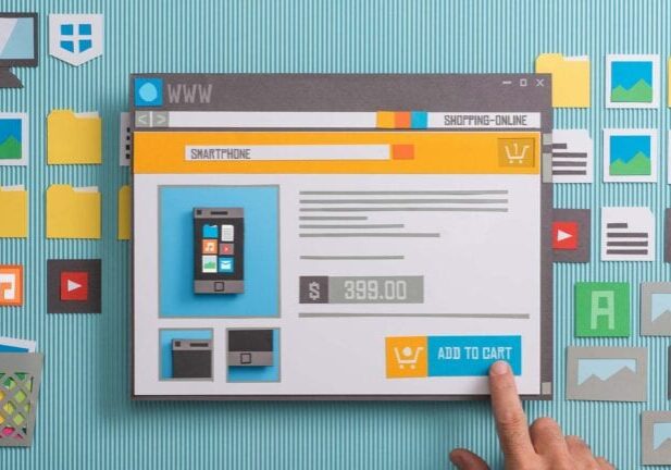 Cardboard cutouts of a mock website design ecommerce layout.