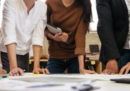 Five business people collaborating in a team meeting.