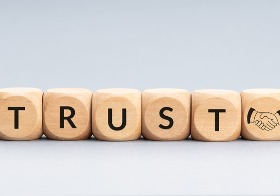 Wooden beads spelling the word Trust.